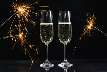 glasses with champagne and sparkles