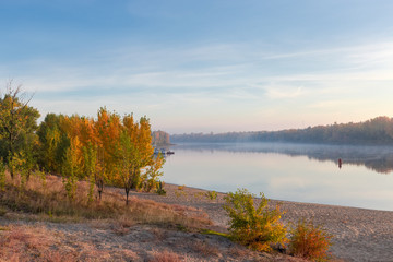 Fototapeta na wymiar Section of plain river with sandy bank autumn at sunrise