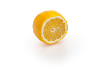 Half of Meyer lemon on a white background