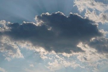 Sunlight bursts from clouds in the sky