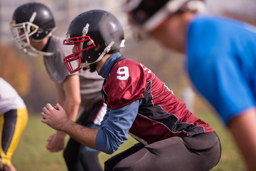 american football players stretching and warming up