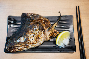 Grilled salmon head on the plate