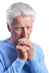 Portrait of thoughtful senior man posing on white background