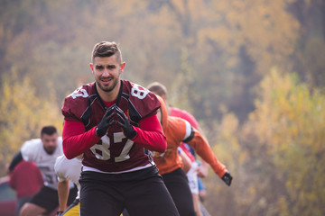 Fototapeta premium american football players stretching and warming up