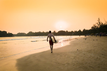  Unidentified  surfer on sunset at  Weligama beach , Sri Lanka.