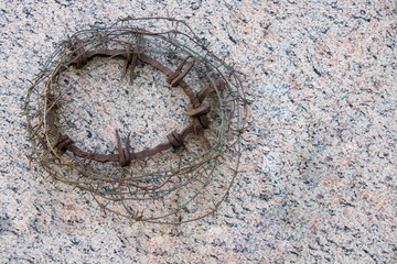 wreath of barbed wire against the background of granite