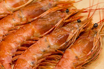 set of langoustine morselic delicacies in shell large with head and black eyes close-up of dietary dish