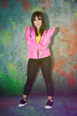 Young hip hop dancer in a pink jacket on studio
