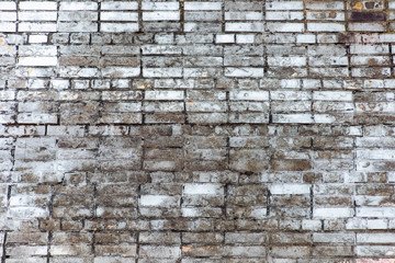 Worn wall of white brick