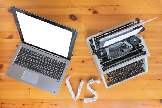 Old typewriter vs new laptop on the table. Concept of technology progress.
