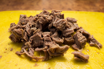 cooked meat on a yellow board