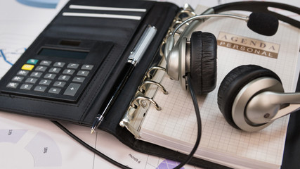 Obraz na płótnie Canvas Close-up, headset lying on an organizer notepad.