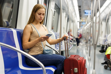Woman using phone inside subway