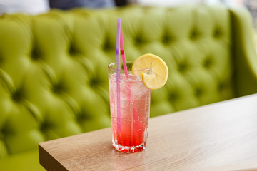 alcoholic red cocktail with lemon