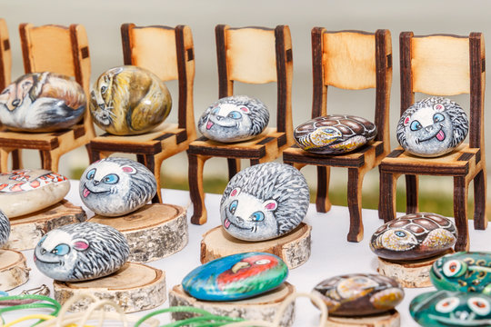 Souvenirs from painted marigolds are exposed for sale on a street tray