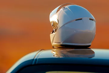  A Racing Helmet Sitting On Top Of A Car In The Early Morning Sun © SIX60SIX