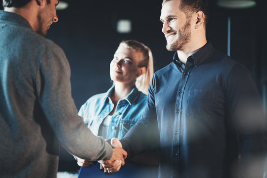 Startup and millenial business concept. Handshake of the partners after successful meeting