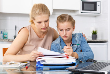 Fototapeta premium Woman supporting her upset daughter
