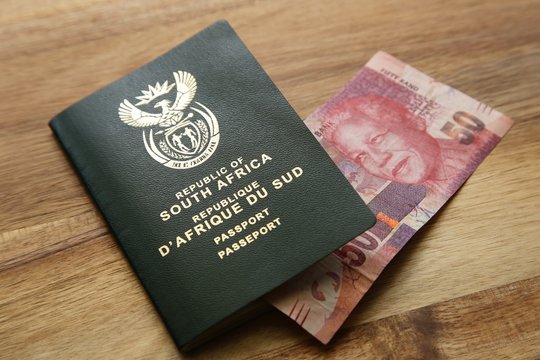 South African Travel Passport And A 50 Rand Note. Travel Money Concept Image. 