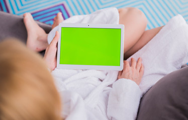woman is relaxing on comfortable couch and using laptop at home