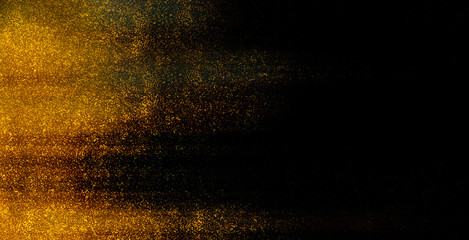 Blurred motion. Golden shiny paint particles on black background. Abstract illustration with glowing blurred lights. Copy space