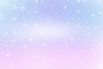 Fototapeta na wymiar Winter shiny snowflakes blurred background in light blue pink colors. Blurry Christmas holiday background with snow flakes, frost pattern, soft flares of light. Copy space
