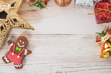 Beautiful Christmas composition and decoration with baked gingerbread man cookie on light wooden background, flat lay, top view, copy space (text space)