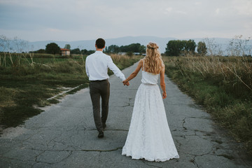 bride and groom on a road