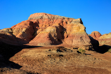 Rainbow City, Wucai Cheng. Colorful Red, Pink, Orange and Yellow landforms in a remote desert area of Fuyun County - Altay Perfecture, Xinjiang Province Uygur Autonomous Region, China. Exotic Scenery