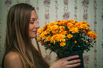 Girl sniffing a large bouquet of flowers in the pot