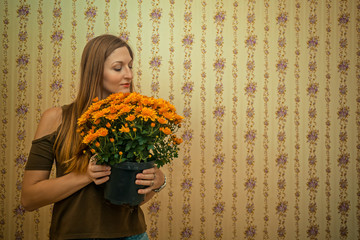 Girl sniffing a large bouquet of flowers in the pot