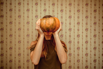 Girl holding pumpkin