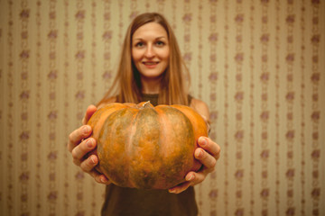 Girl unfocused holding pumpkin