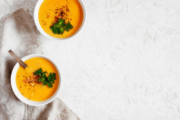 Two portion of pea soup with smoked meat and parsley