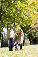 Fototapeta premium family with a baby in autumn park