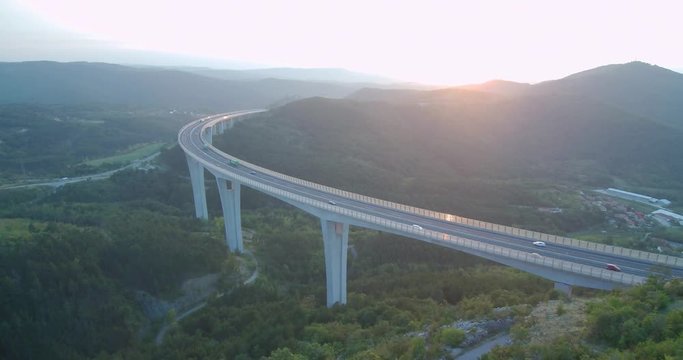 4k aerial footage of traffic over viaduct at sunset