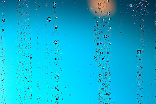 fresh drops background blue glass / wet rainy background, water drops transparent glass blue © kichigin19