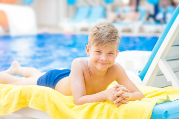 Little boy by the pool.  Relaxation resting vacations concept