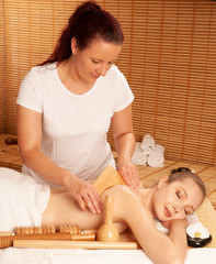 Beautiful young woman having a maderotherapy massage  treatment in spa salon - wellness