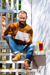 businessman male brunette beard glass hold cafe office house brave bearded hipster mulled wine garden table work tablet