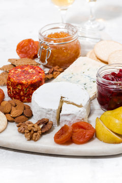 assortment of snacks, cheeses, nuts and fruits, vertical