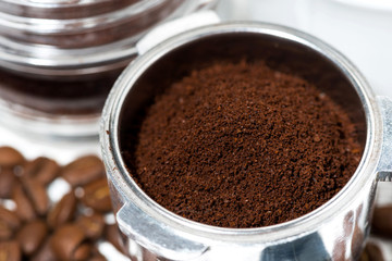 holder with aroma ground coffee on table, closeup