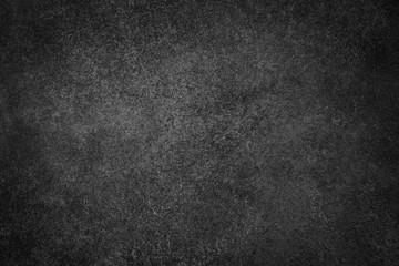 Dark black slate background. Stone or concrete surface