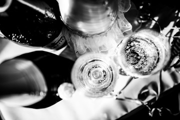 Fototapeta premium two glasses of champagne on the holiday wedding table top view two glasses of champagne on the holiday wedding table top view black and whiite