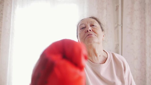 An old senior woman boxing