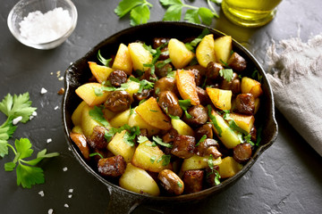 Fried potatoes with mushroom and sausage