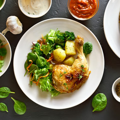 Grilled chicken leg with potato and green salad