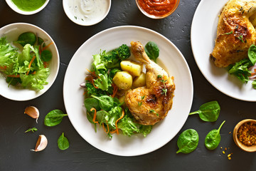 Fried chicken leg with potato and green salad