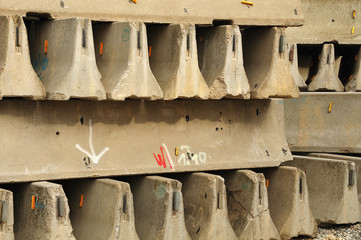 stack of concrete roadwork crash barriers