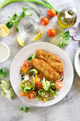 Vegetable salad and breaded chicken breast